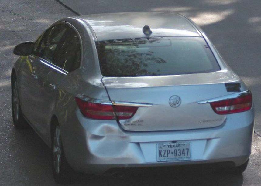 Photo of the back of a silver Buick sedan with a large dent in the rear left bumper. License plate number: KZP347.